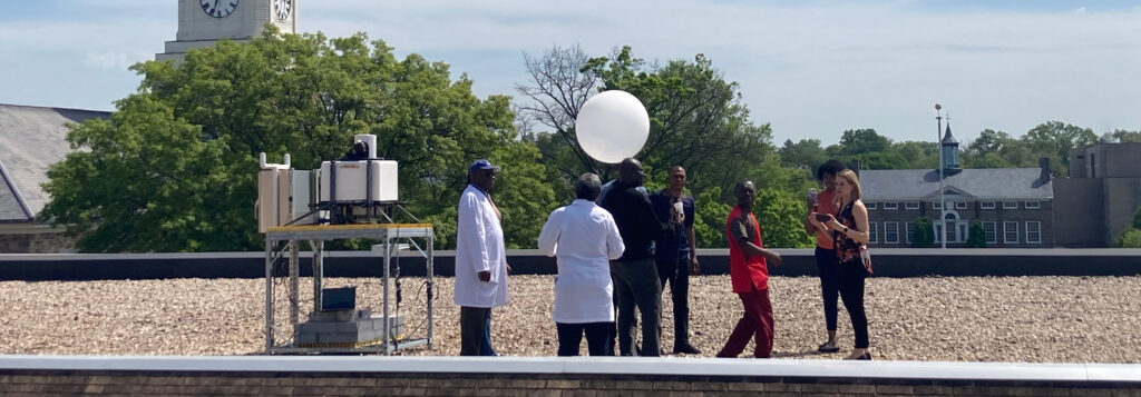 BSEC members on roof with weather balloon