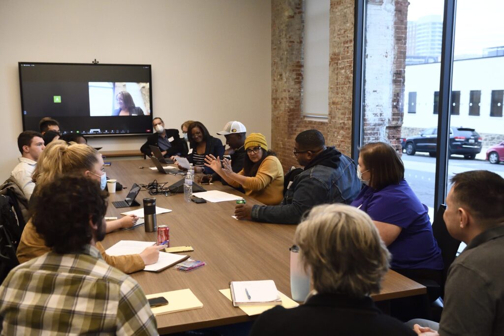 A dozen BSEC members sitting around a conference table at the kickoff meeting